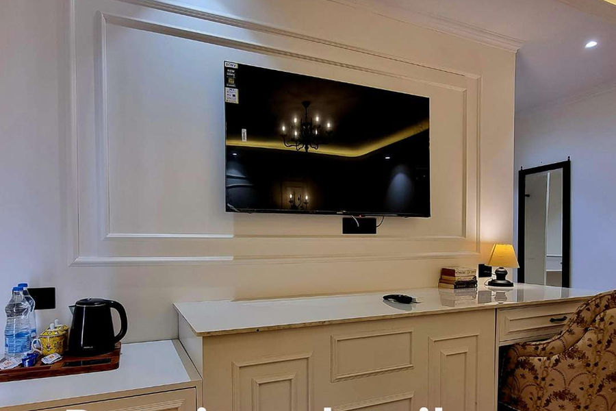 55-inch Sony Smart TV with complimentary tea-coffee maker and bottled water in room at Akasa Dalhousie